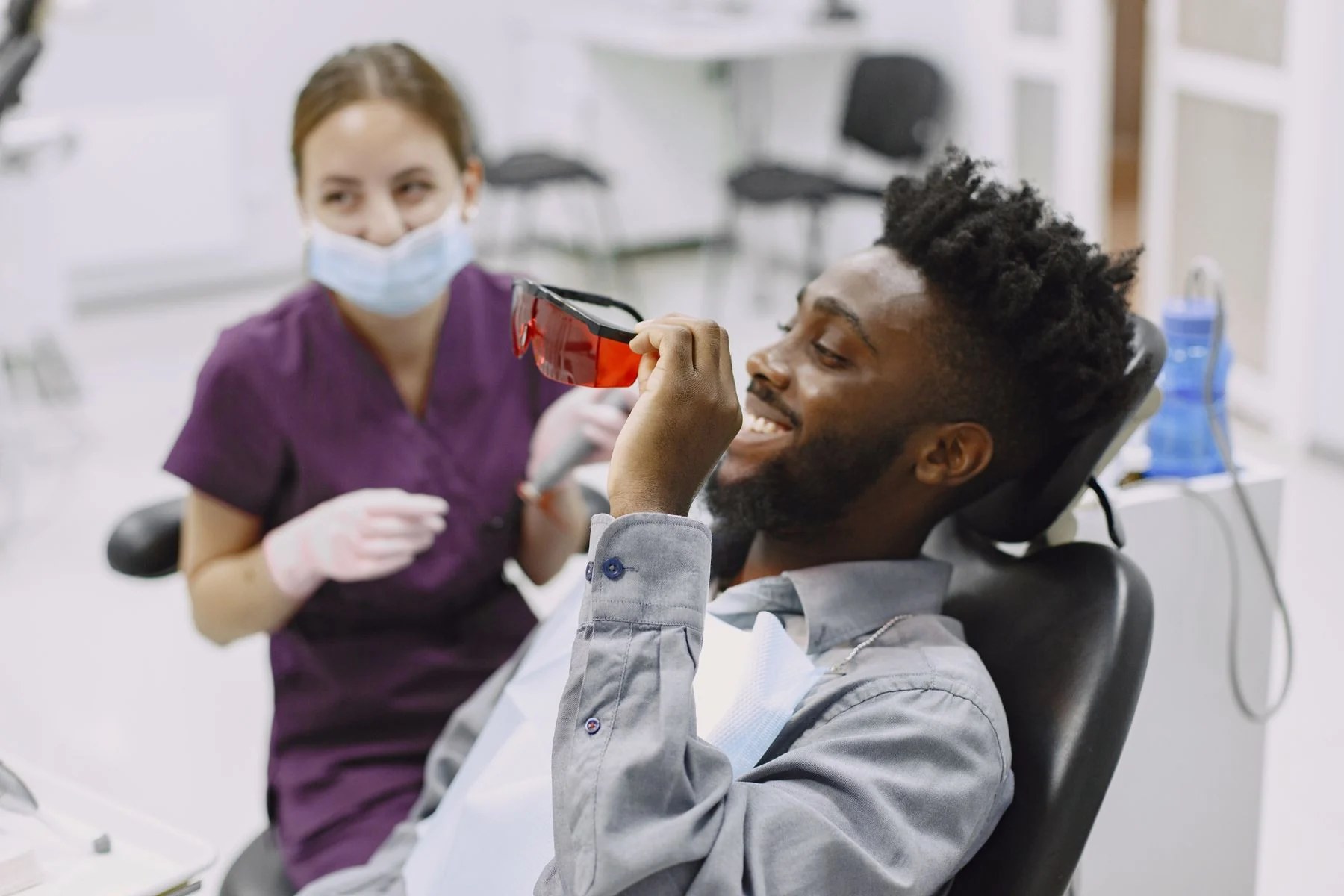 Dentist speaking with a patient during a consultation; representative photo